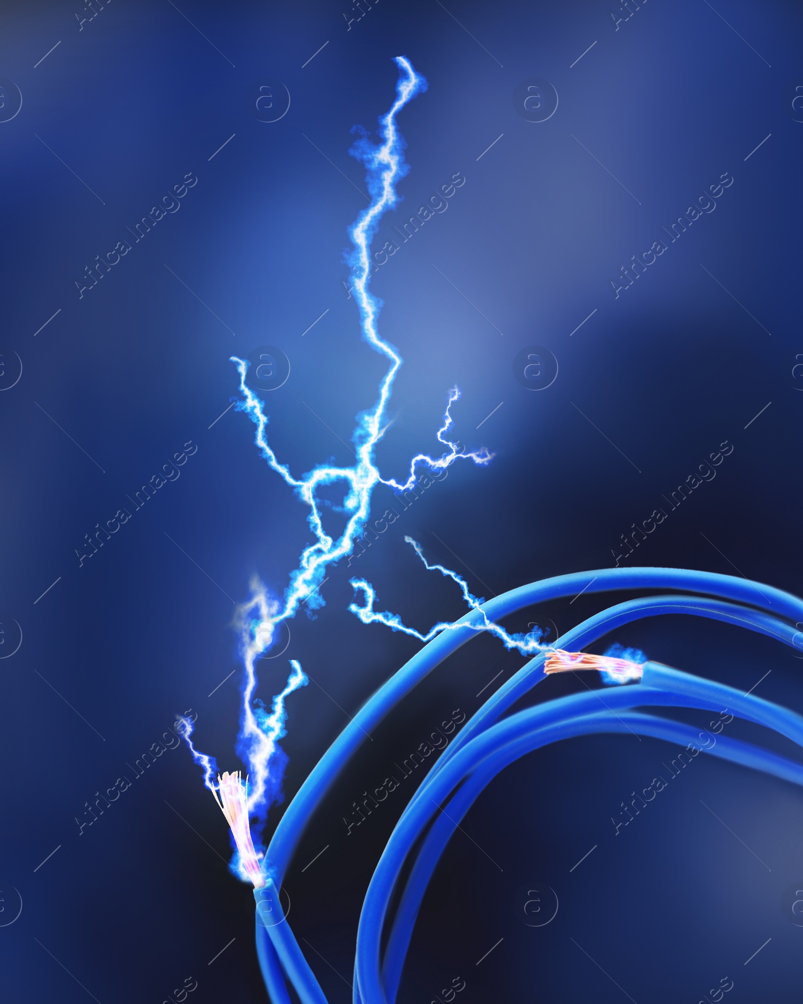 Image of Sparking cables on dark blue background, closeup. Electrician's supply