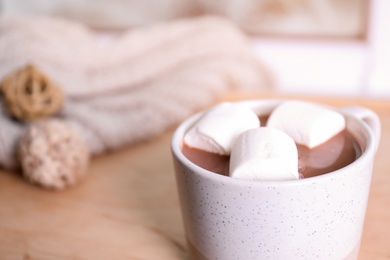 Cup of aromatic cacao with marshmallows on blurred background, closeup. Space for text