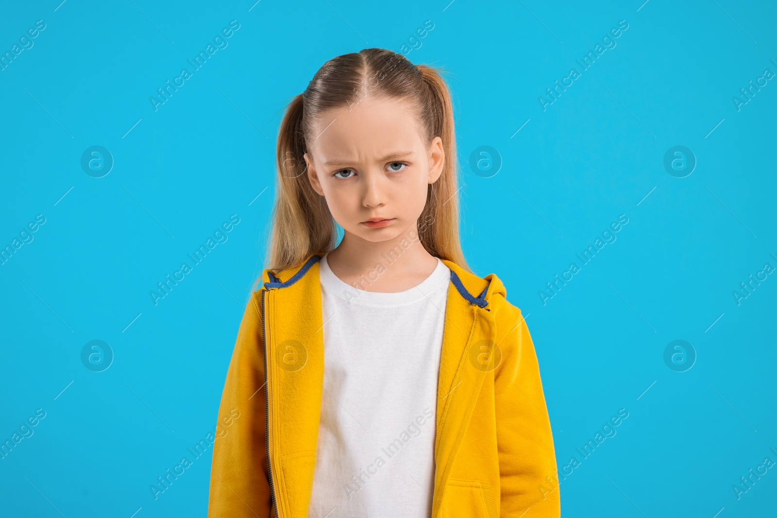 Photo of Portrait of sad girl on light blue background