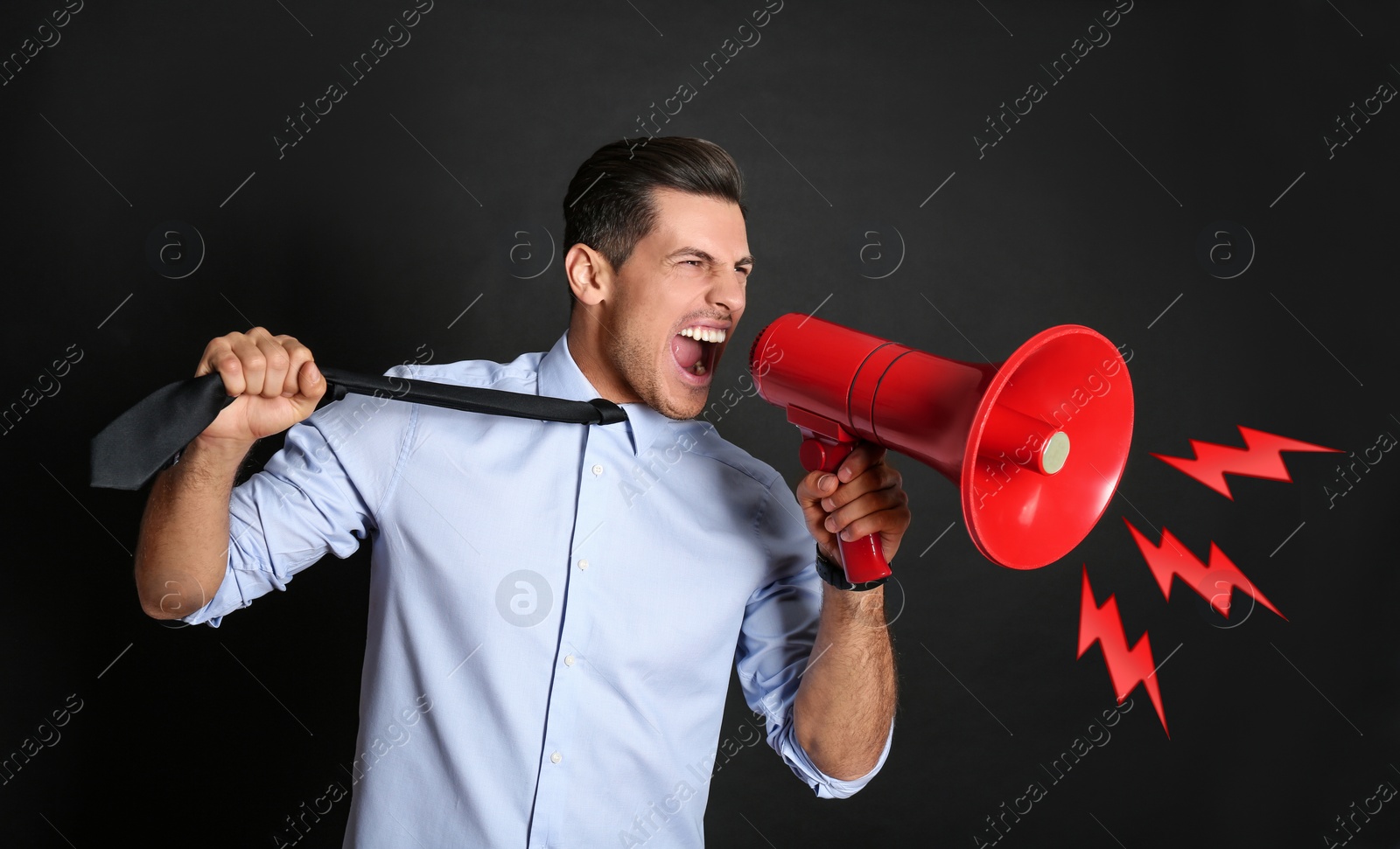 Image of Handsome man with megaphone on black background