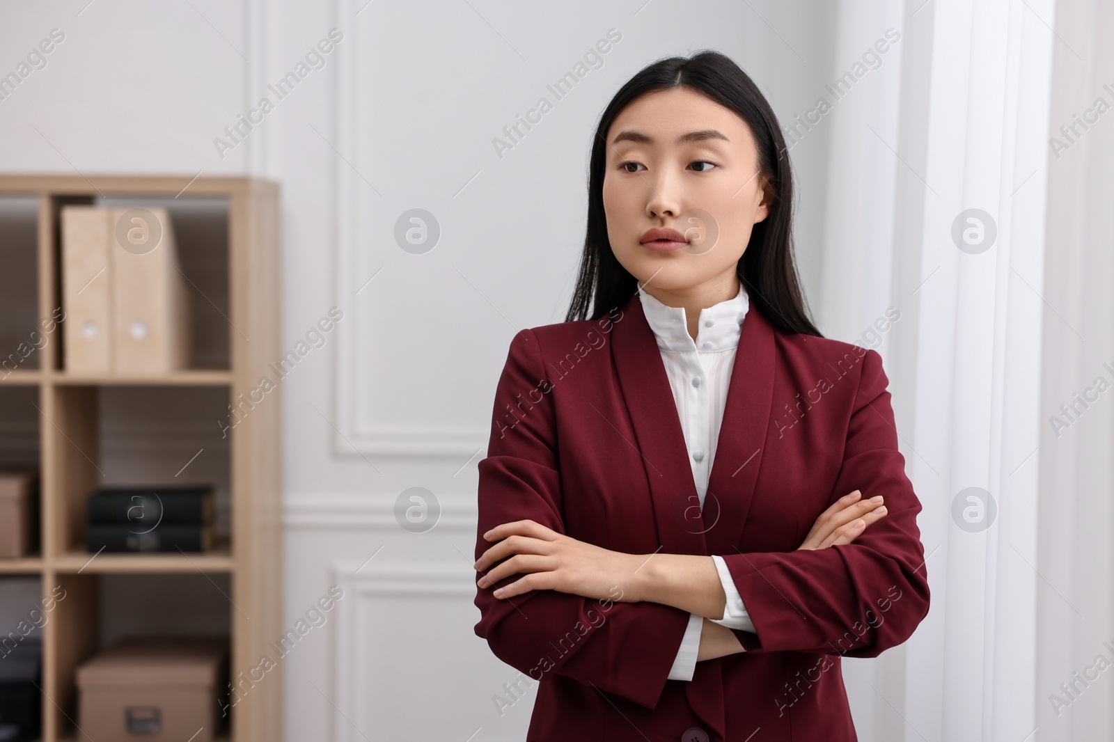 Photo of Portrait of notary with crossed arms in office. Space for text