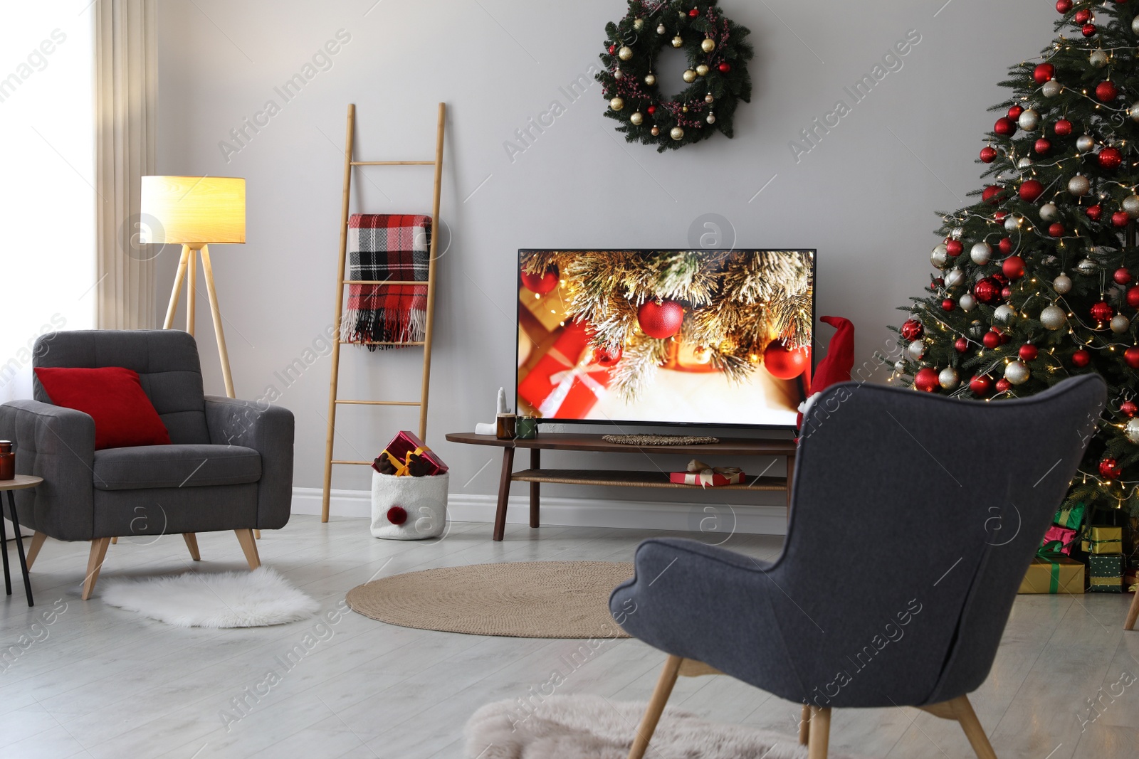 Photo of Stylish living room interior with modern TV and Christmas tree