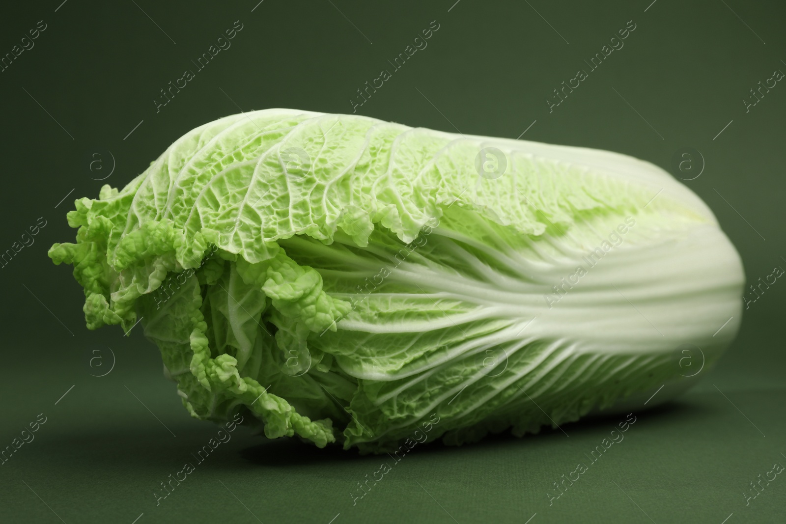 Photo of Fresh ripe Chinese cabbage on green background, closeup