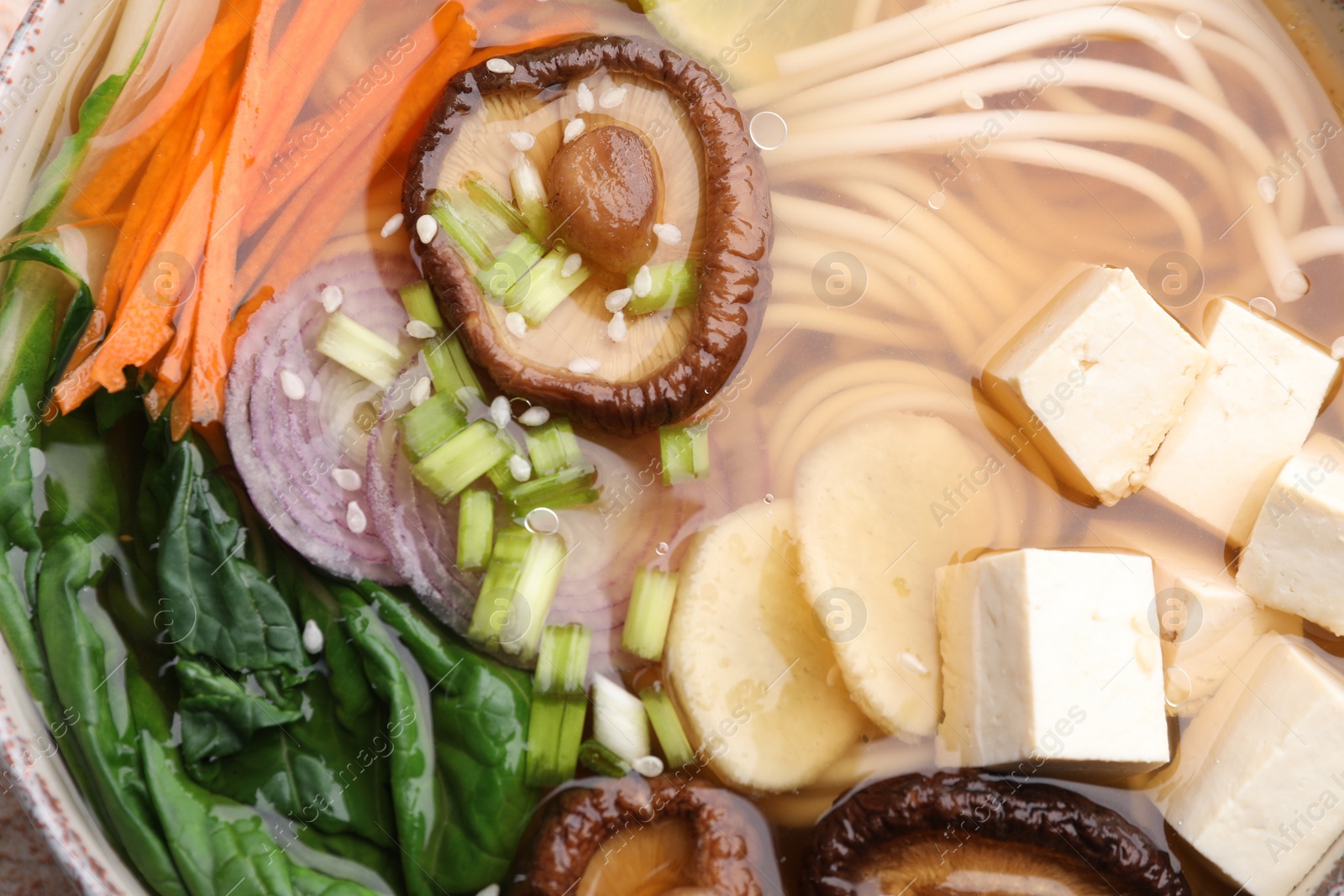 Photo of Delicious vegetarian ramen in bowl, top view