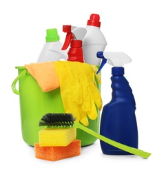 Photo of Bucket with different cleaning products and tools on white background