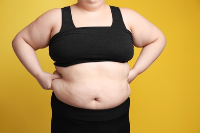 Overweight woman on color background