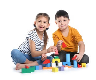 Photo of Cute children playing with colorful blocks on white background