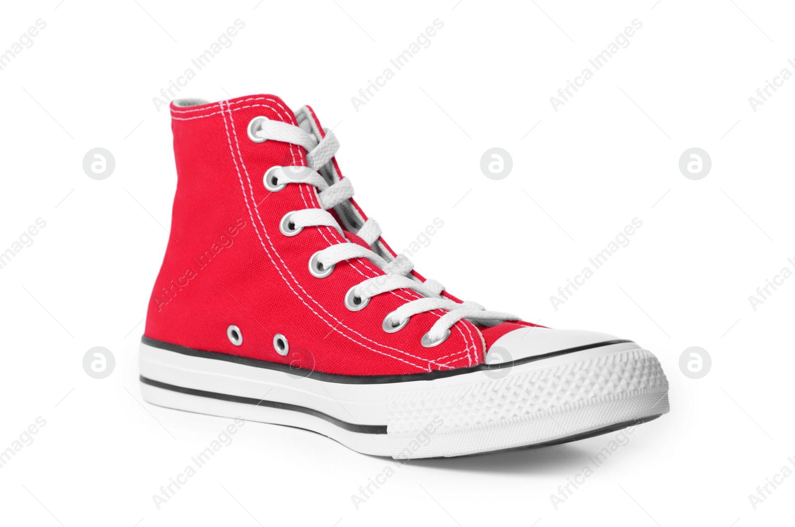 Photo of One new red stylish high top plimsoll on white background