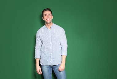 Portrait of handsome man posing on color background. Space for text