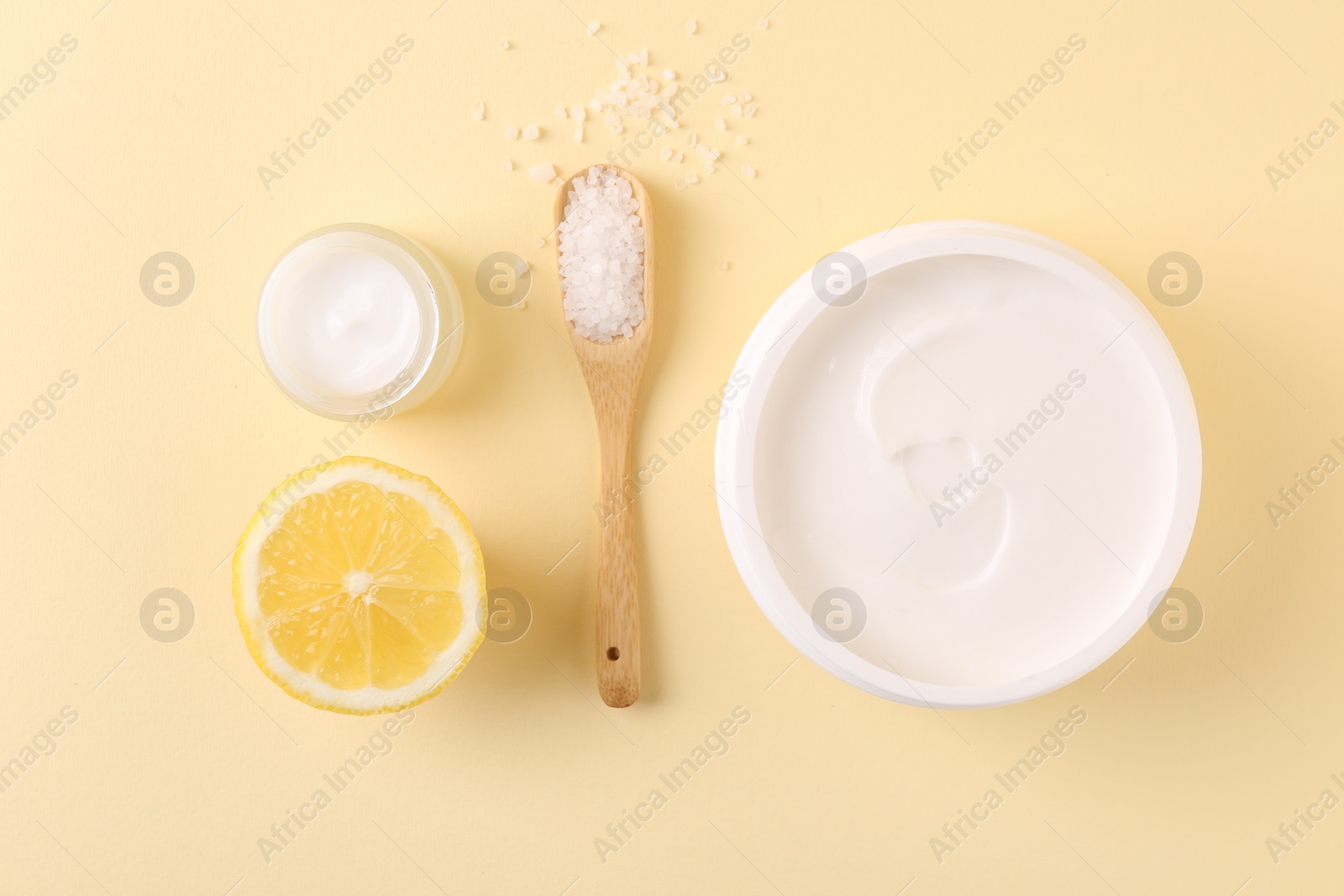 Photo of Flat lay composition with jars of cream on beige background. Body care product