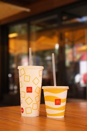 MYKOLAIV, UKRAINE - AUGUST 11, 2021: Cold McDonald's drinks on table in cafe