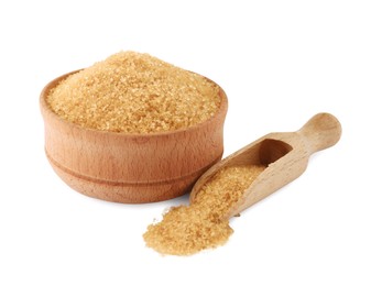 Wooden bowl and scoop of granulated brown sugar on white background