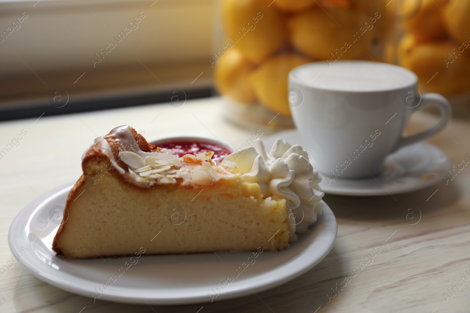 Photo of Delicious dessert and cup of aromatic coffee on white wooden table, closeup