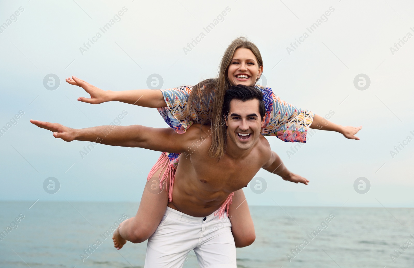Photo of Happy young couple having fun on sea beach