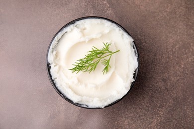 Delicious pork lard with dill in bowl on brown table, top view