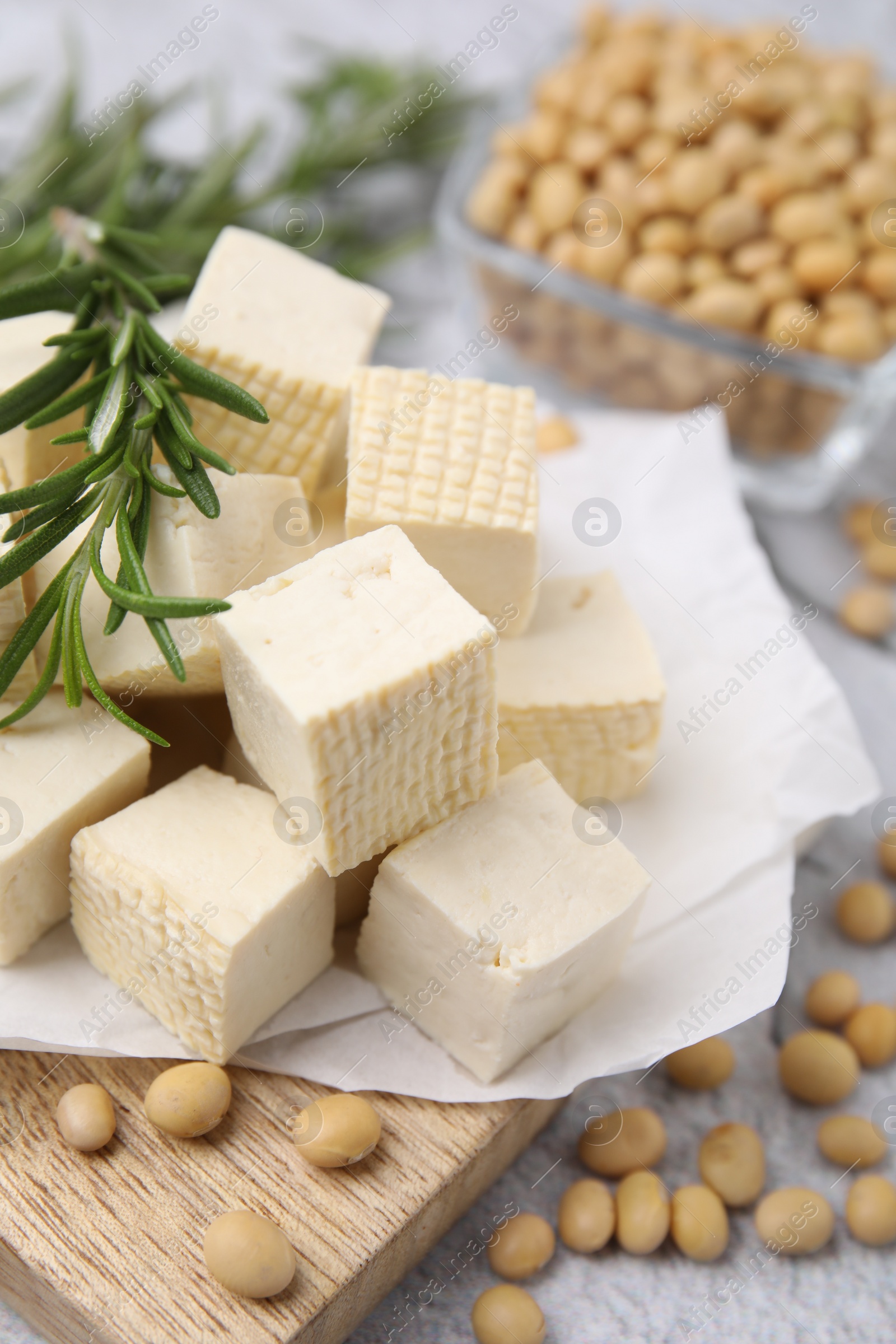 Photo of Delicious tofu cheese, rosemary and soybeans on table, closeup