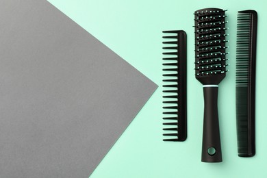 Stylish hairbrush and combs on color background, flat lay. Space for text
