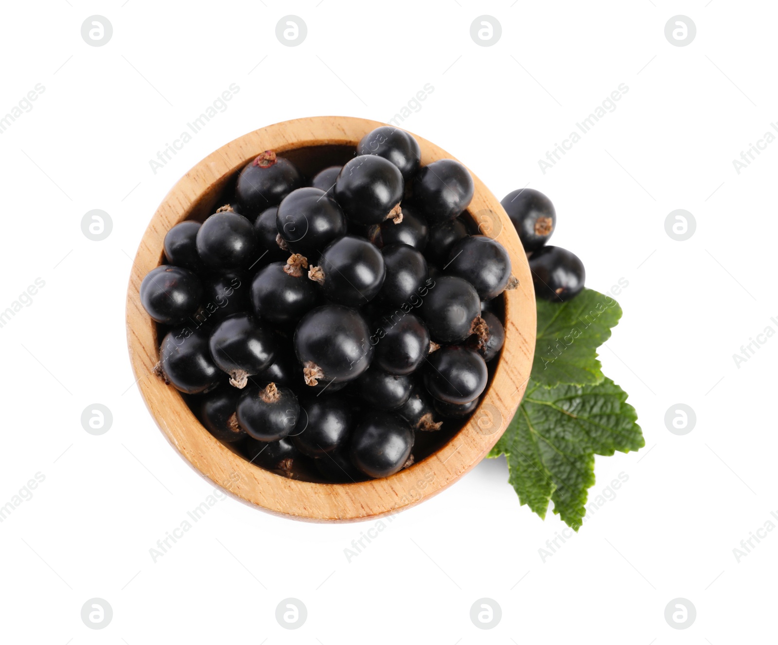 Photo of Ripe blackcurrants and leaves isolated on white, top view