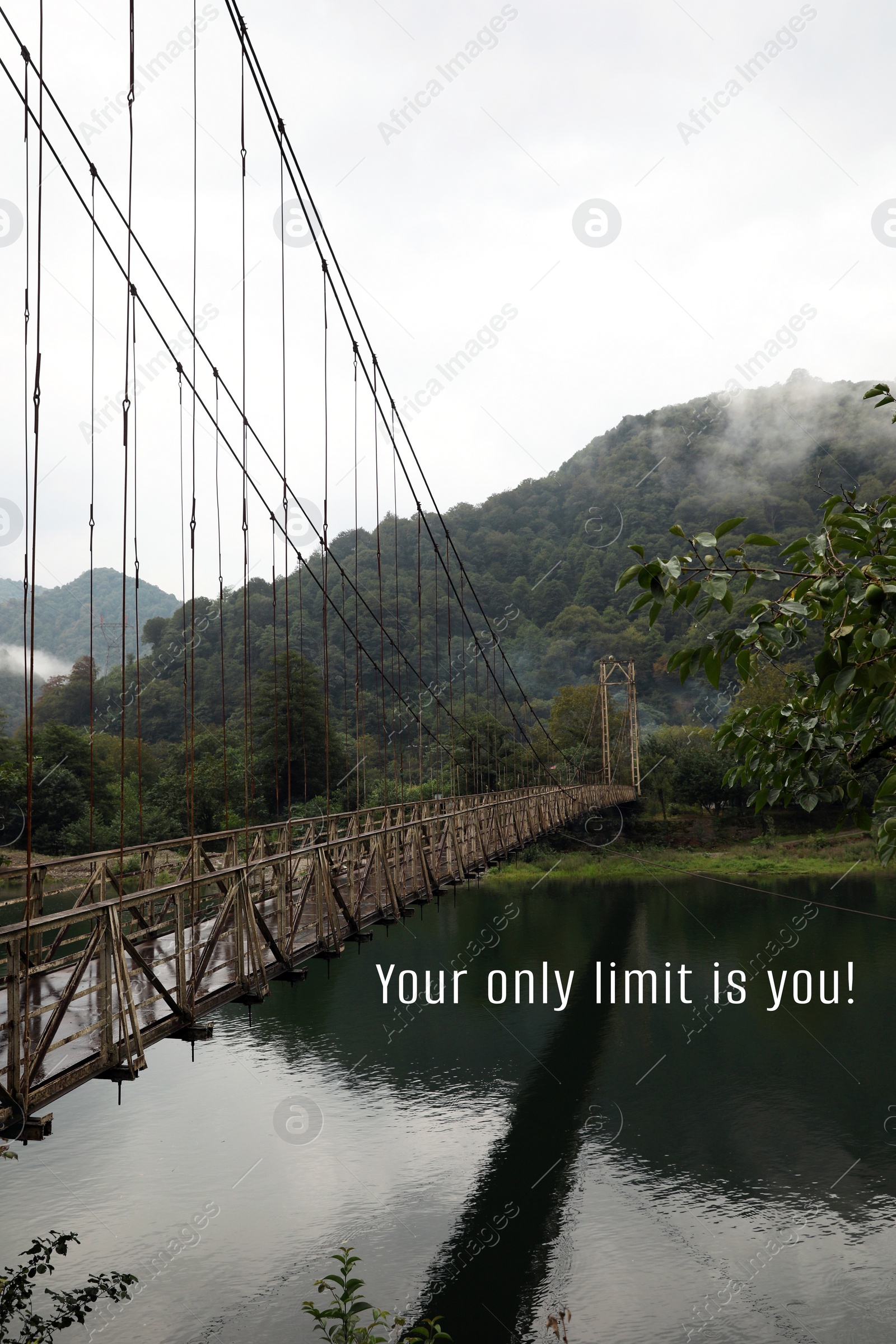 Image of Your only limit is you, affirmation. Rusty metal bridge over river in mountains