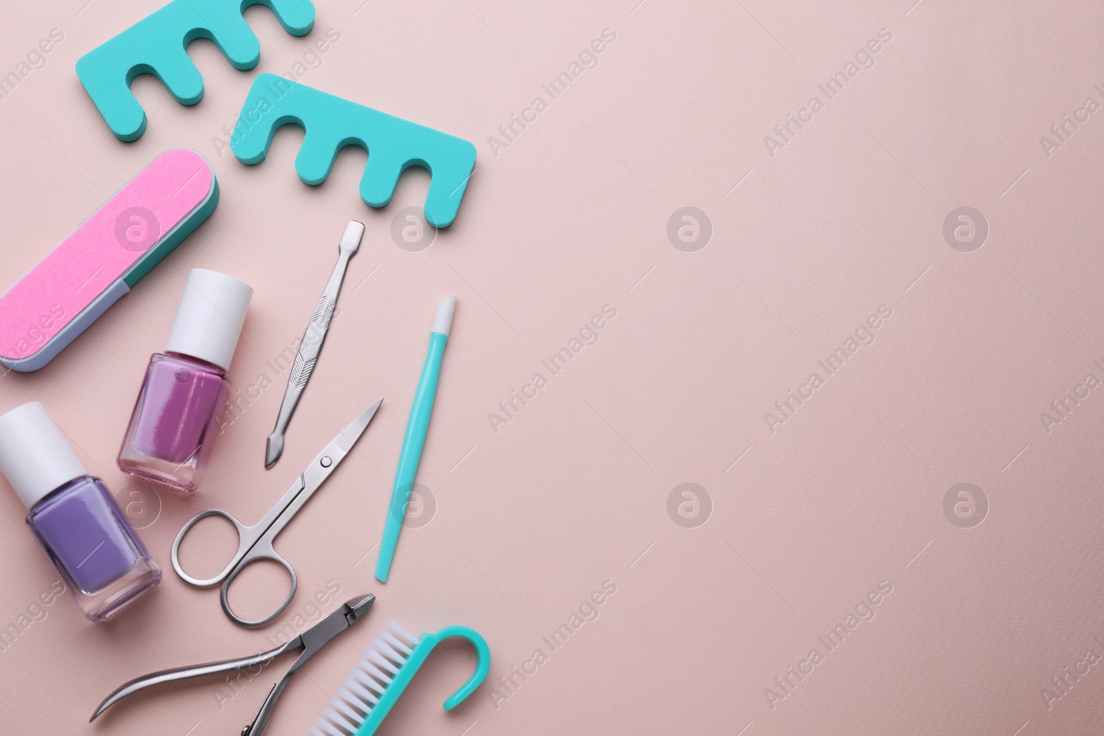 Photo of Set of pedicure tools on pink background, flat lay. Space for text