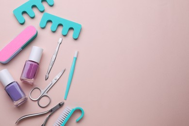 Set of pedicure tools on pink background, flat lay. Space for text