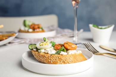 Plate of delicious bruschetta with shrimps on white table