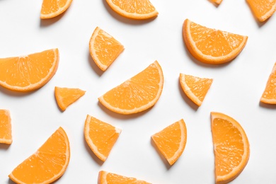 Composition with orange slices on white background, top view