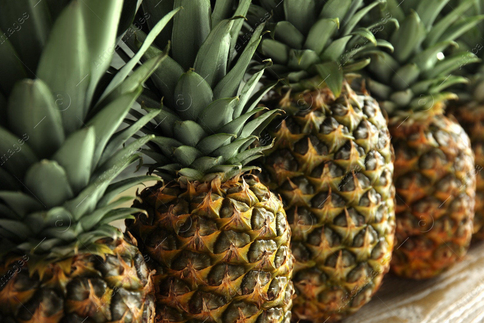 Photo of Closeup view of fresh ripe juicy pineapples