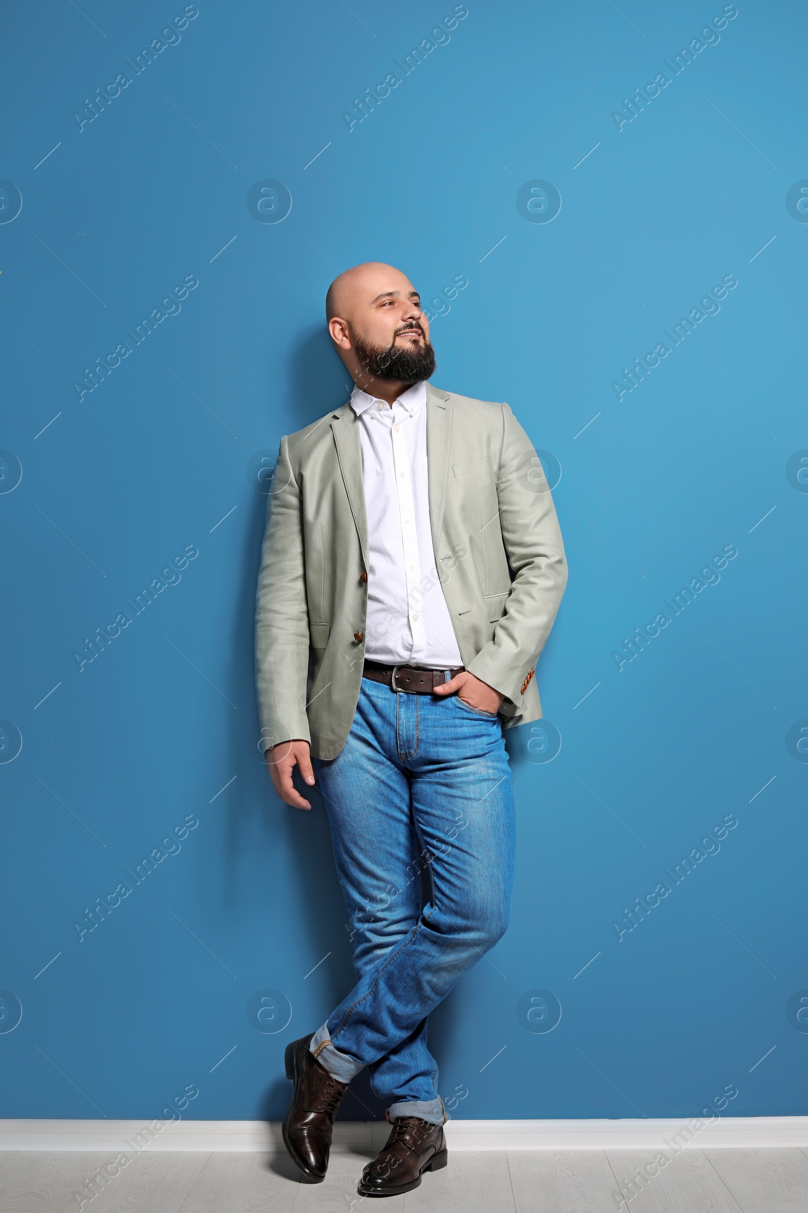 Photo of Portrait of confident young businessman on color wall background