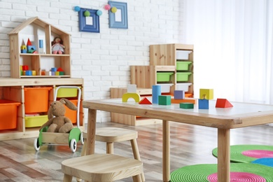 Photo of Modern child room interior with table and stools