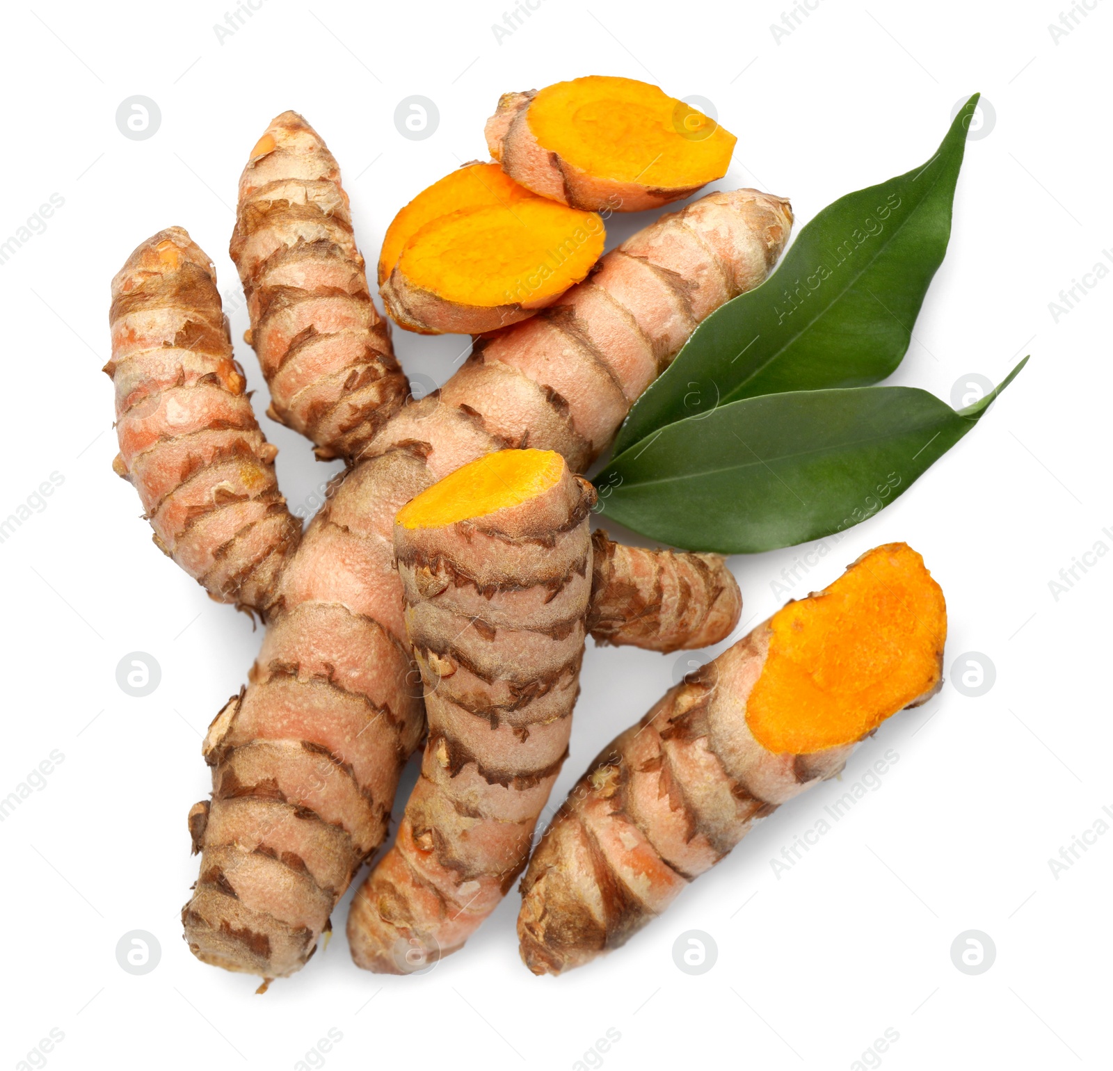 Photo of Fresh turmeric roots and green leaves isolated on white, top view