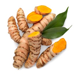 Fresh turmeric roots and green leaves isolated on white, top view