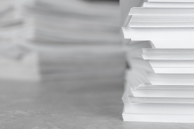 Photo of Stack of blank white paper on table, closeup. Space for text