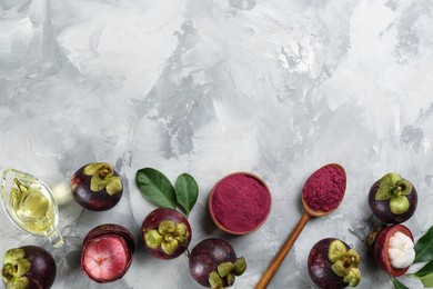 Photo of Purple mangosteen powder and fruits on light grey table, flat lay. Space for text