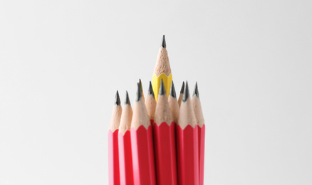 Photo of Red pencils and different one on white background