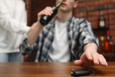 Photo of Woman stopping man from drunk driving, closeup. Don't drink and drive concept