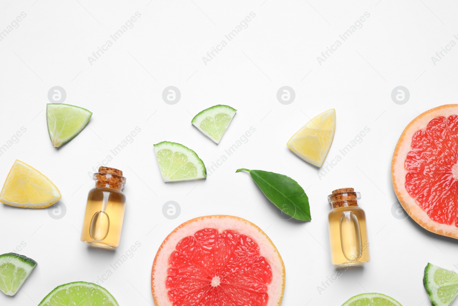 Photo of Flat lay composition with bottles of citrus essential oil on white background