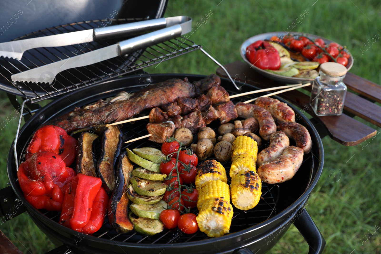 Photo of Tasty meat and vegetables on barbecue grill outdoors