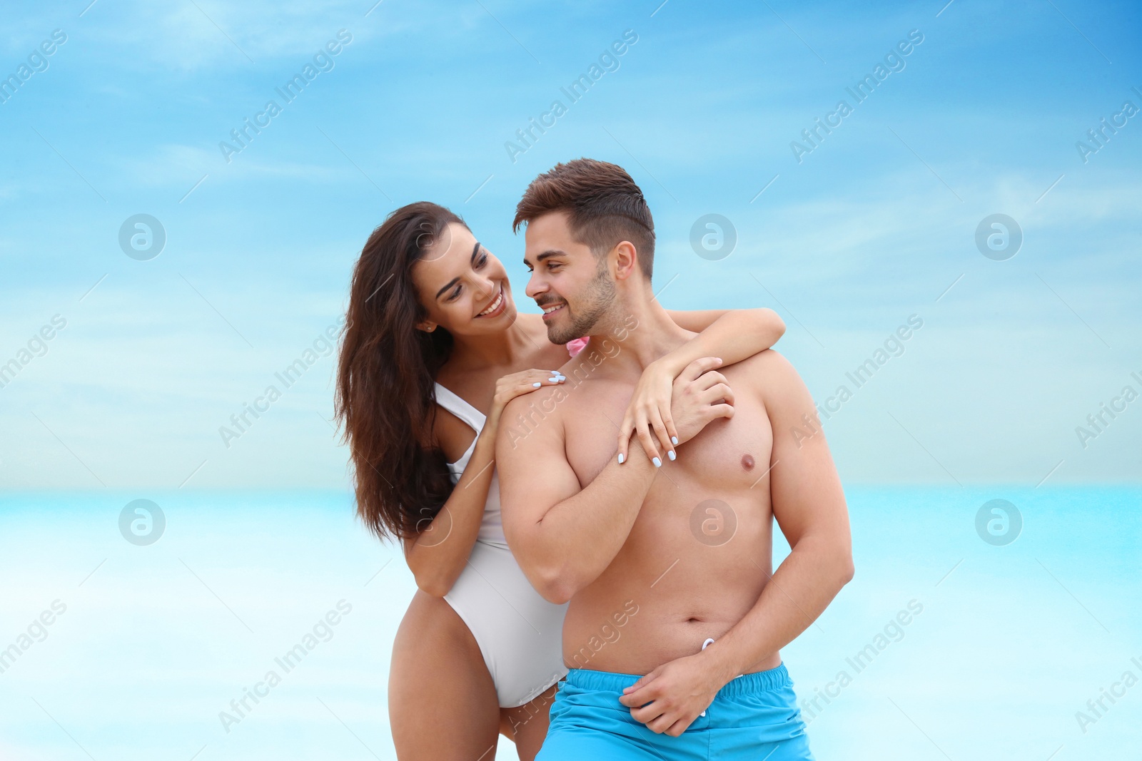 Photo of Happy young couple spending time together on beach