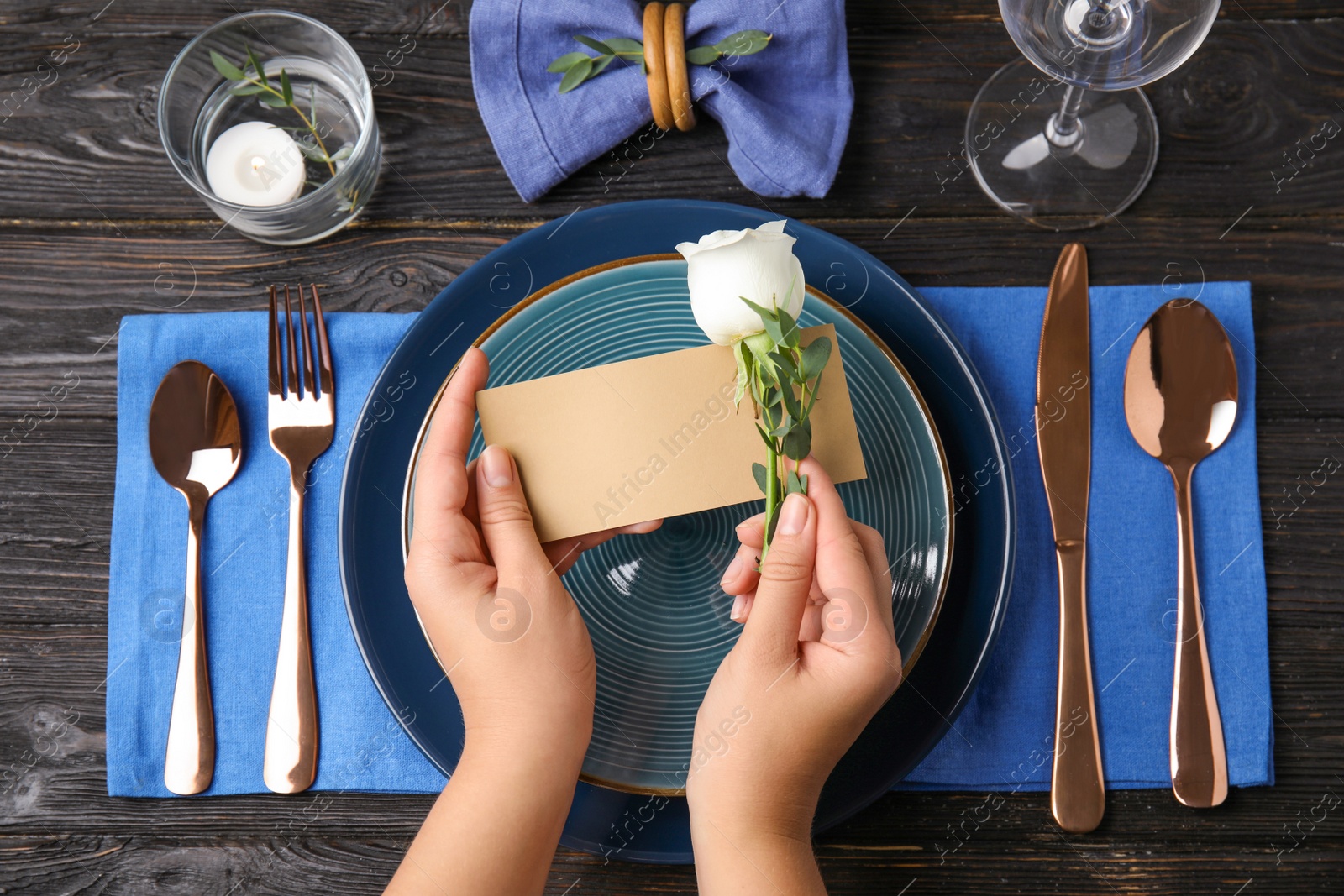 Photo of Woman setting table for festive dinner, top view