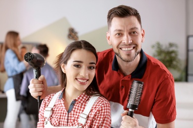 Hairdresser with happy client in beauty salon