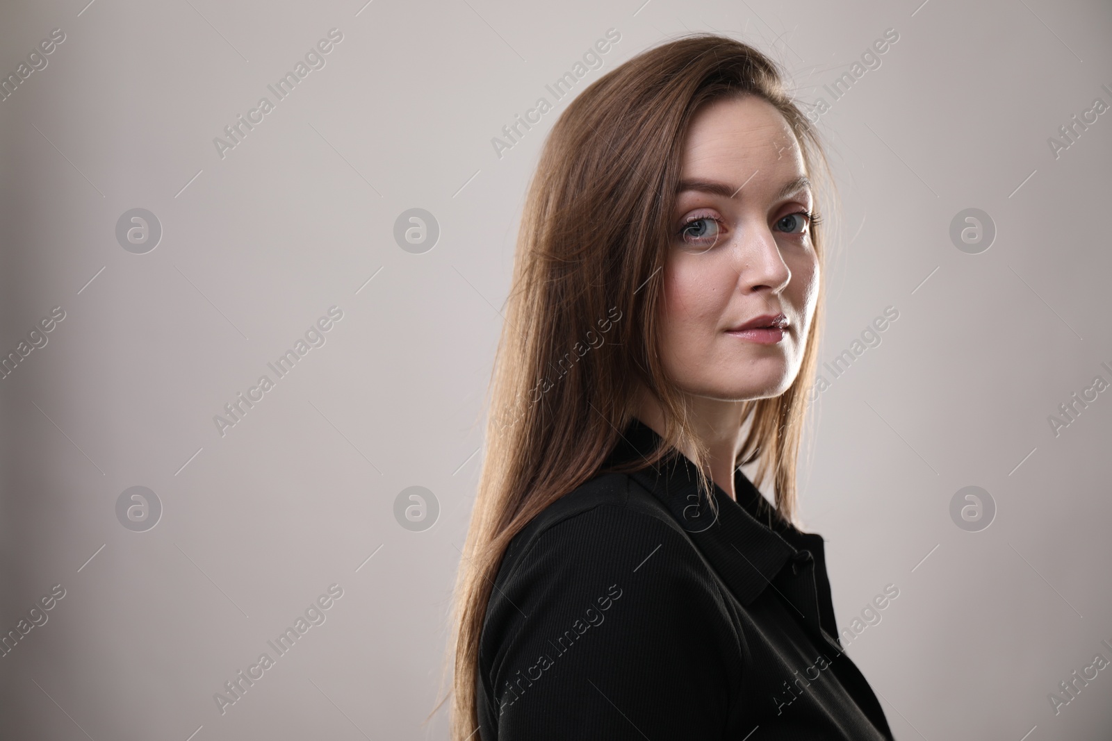 Photo of Portrait of beautiful woman on gray background, space for text