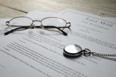Photo of Last Will and Testament, glasses and pocket watch on white table, closeup