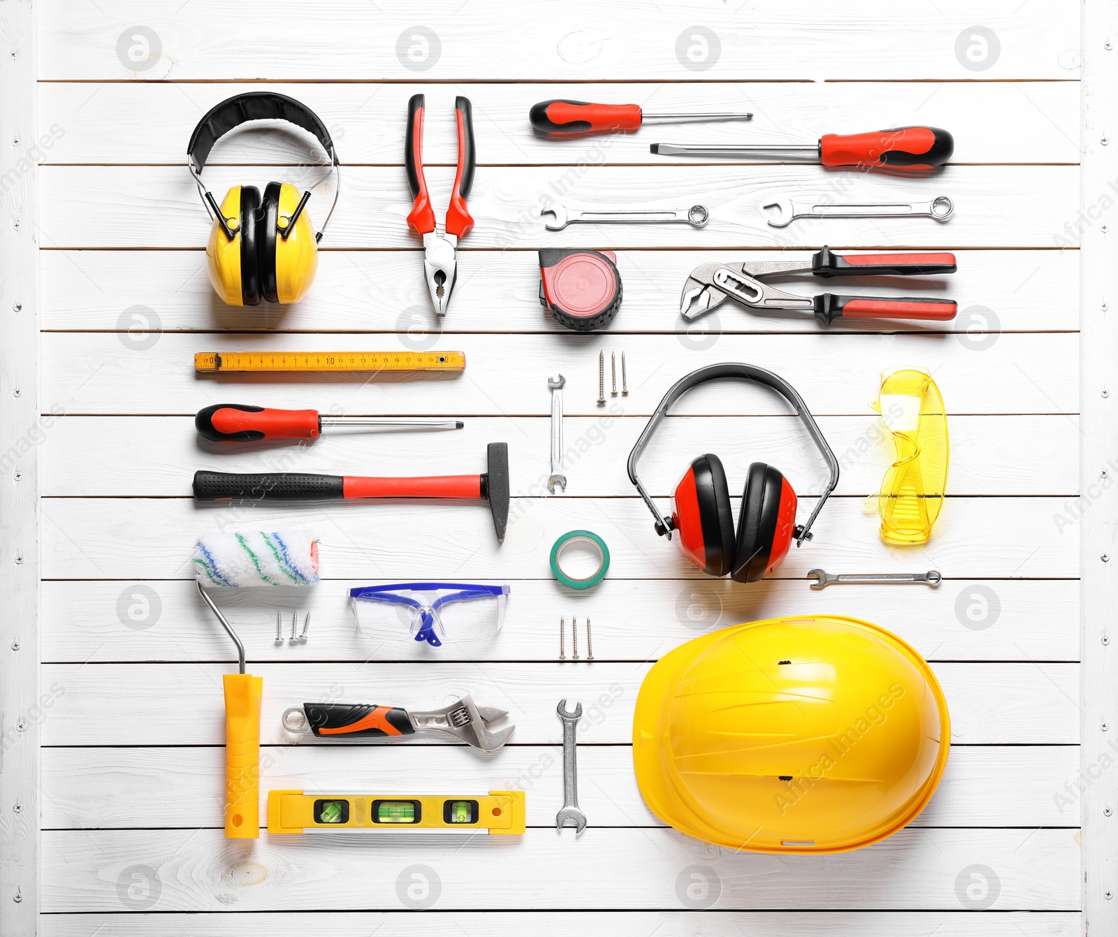 Photo of Flat lay composition with different construction tools on white wooden background