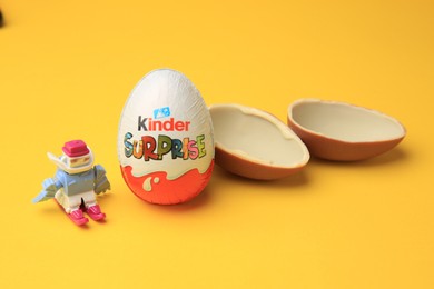 Sveti Vlas, Bulgaria - June 29, 2023: Kinder Surprise Eggs and toy on orange background