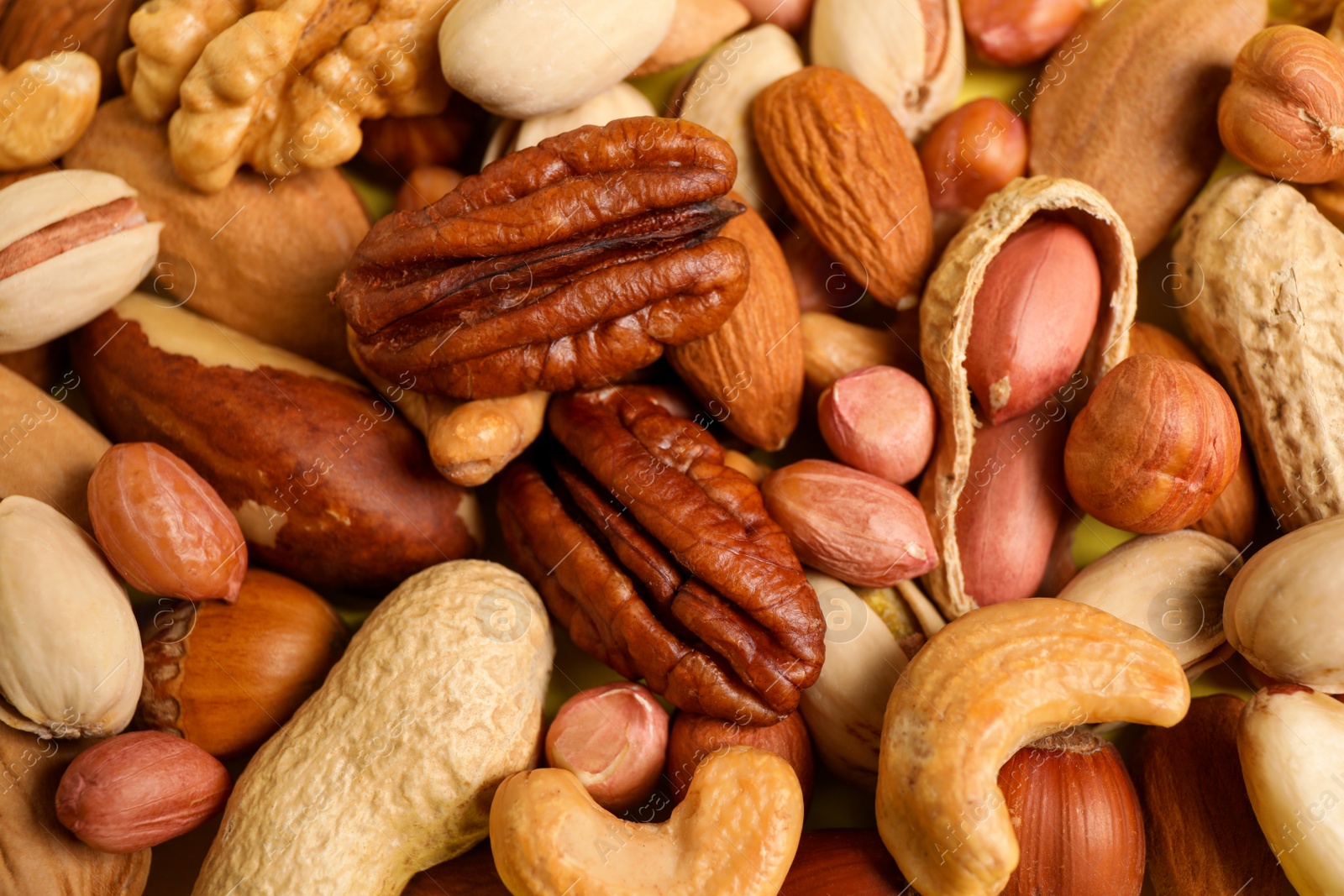 Photo of Different delicious nuts as background, closeup view