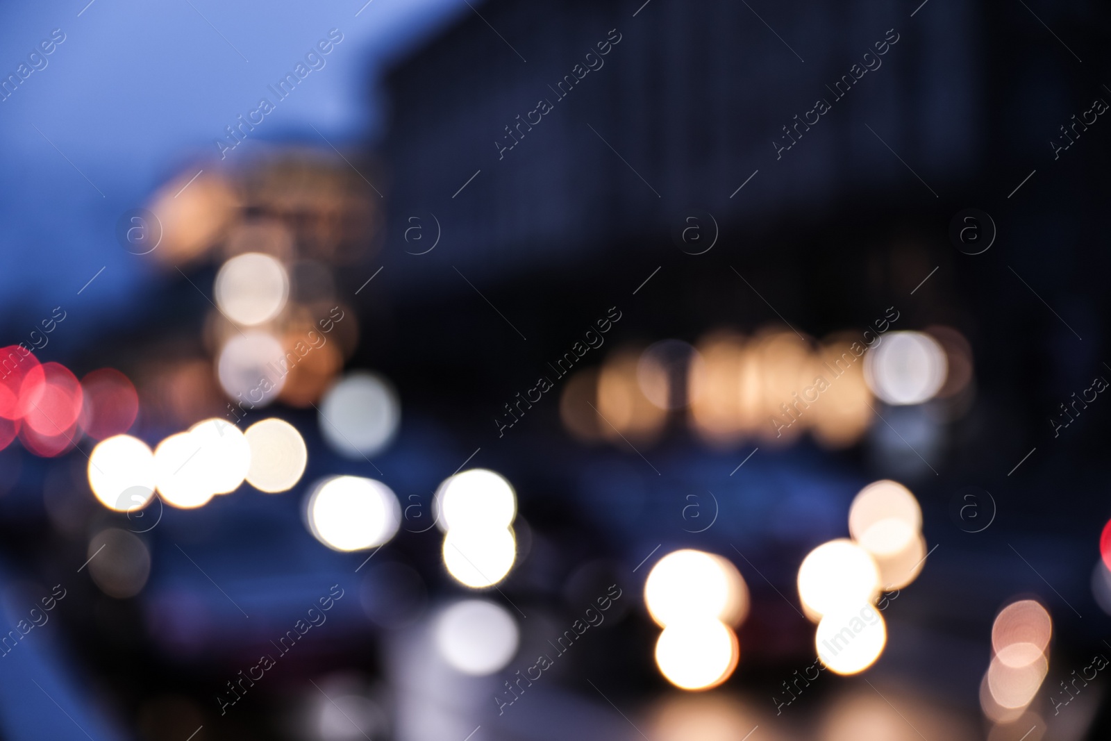 Photo of Blurred view of modern city at evening. Bokeh effect