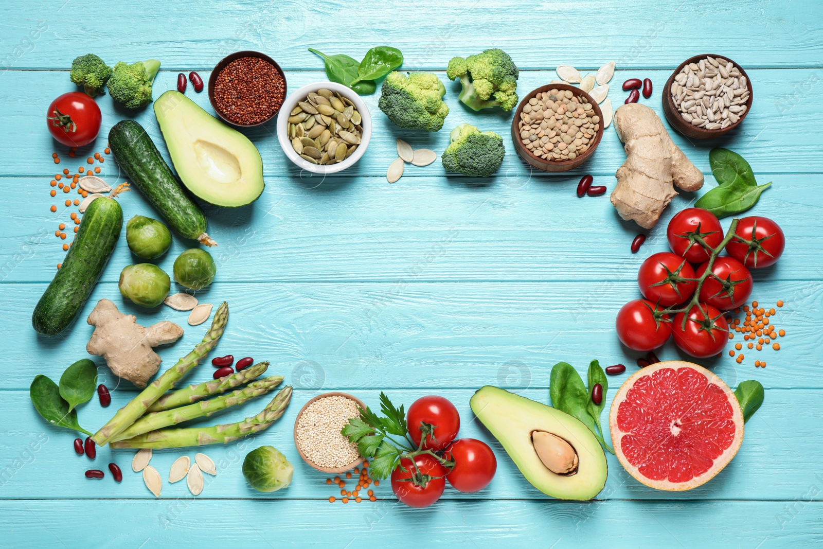 Photo of Frame of fresh vegetables, fruits and seeds on light blue wooden table, flat lay. Space for text