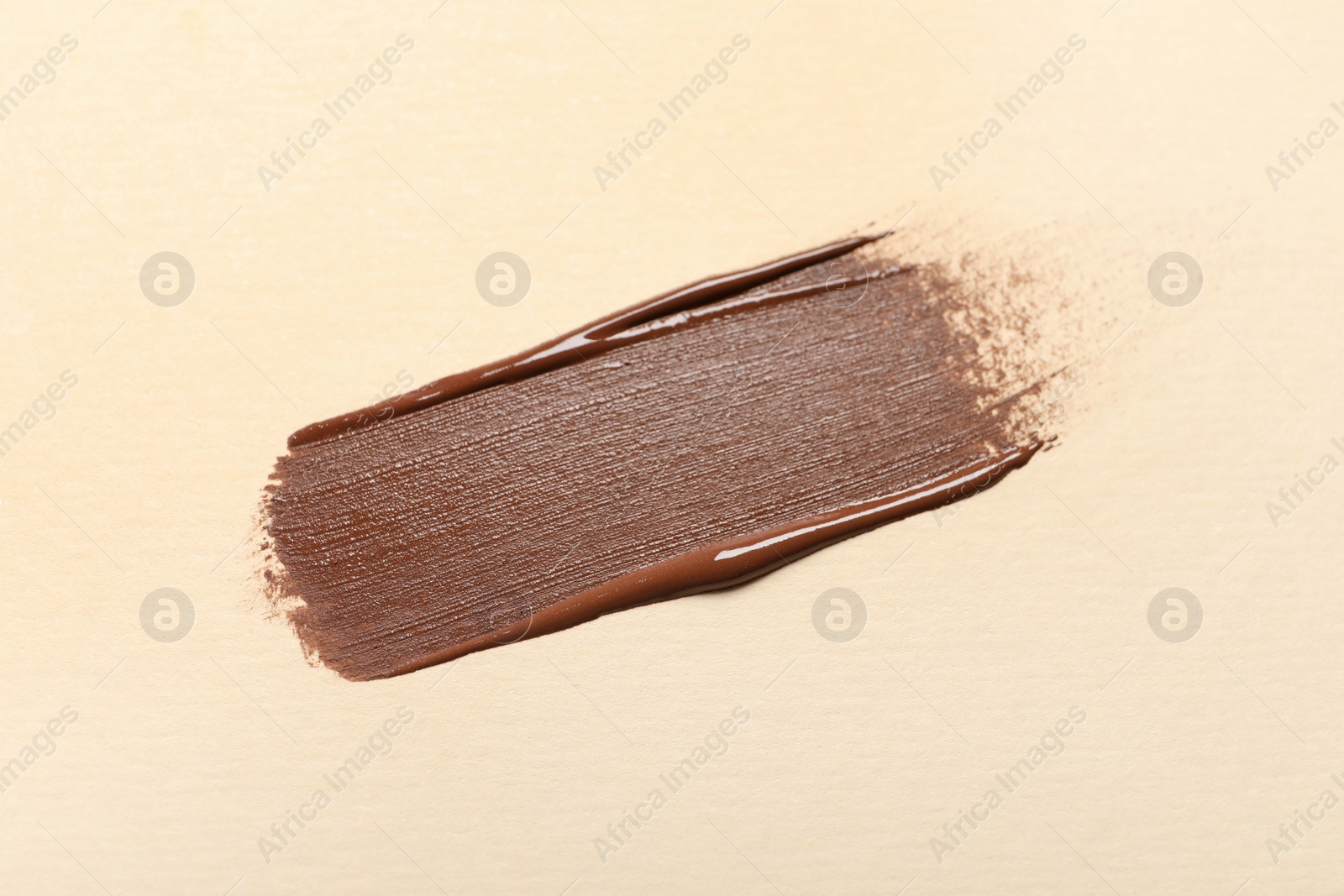 Photo of Smear of skin foundation on beige background