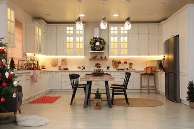 Cozy dining room interior with Christmas tree and beautiful festive decor